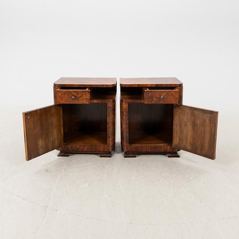 A pair of Art Deco walnut bedside tables.