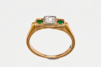 A DIAMOND / EMERALD RING.