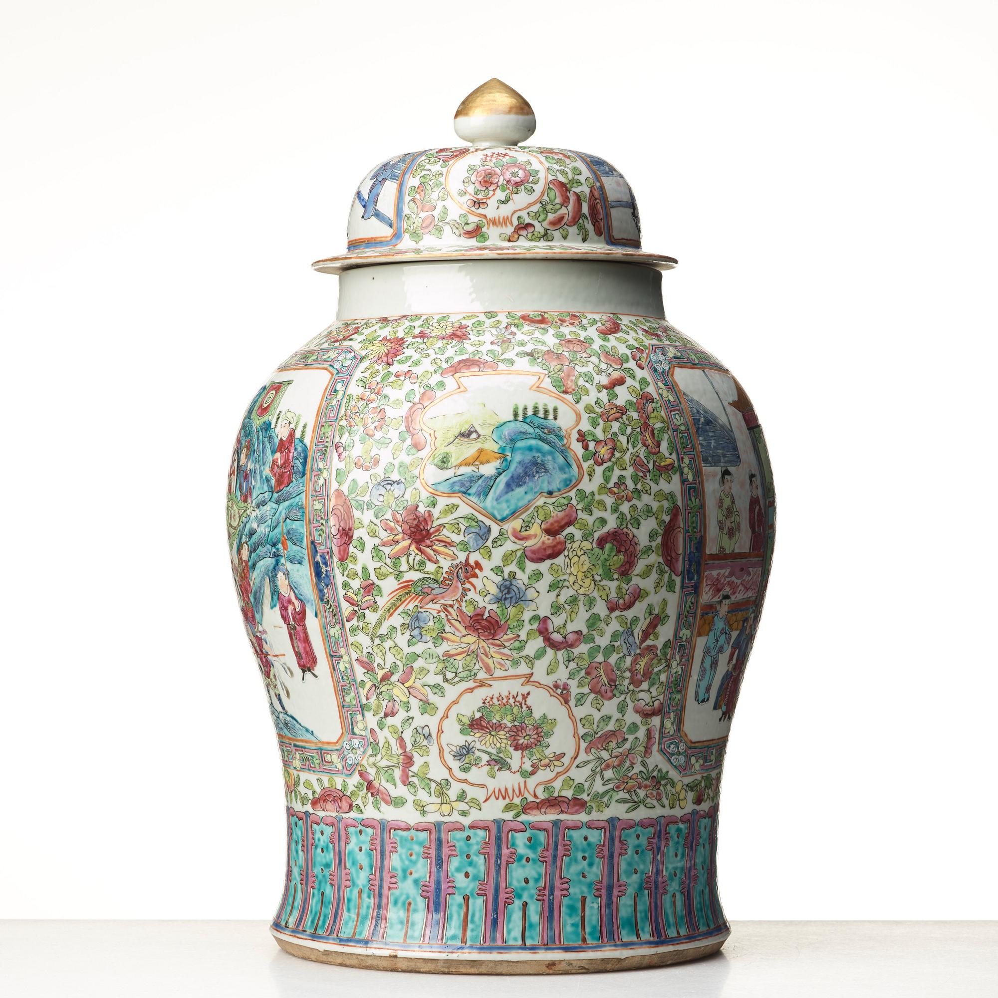 A Canton famille rose jar with cover on a tall wooden stand, Qing dynasty, late 19th Century.