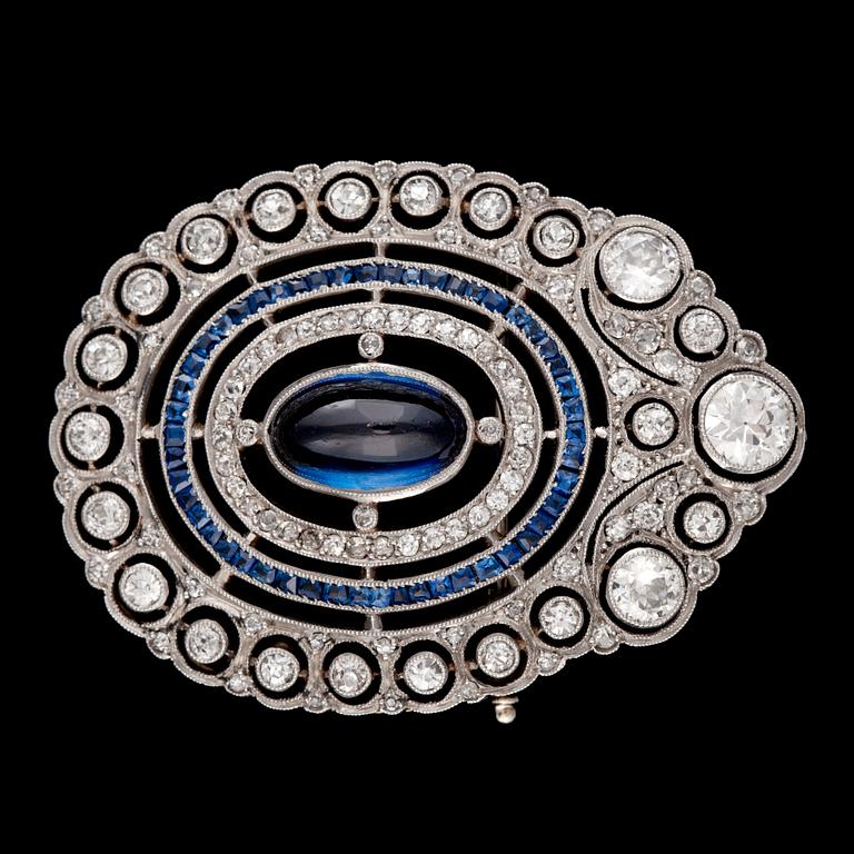 A cabochon synthetic sapphire and old-cut diamond, 2.50 cts in total, brooch.
