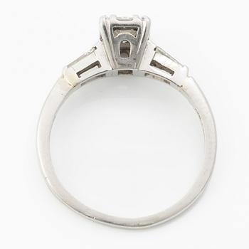 Platinum ring with an emerald-cut diamond and modified baguette-cut diamonds.