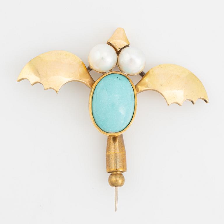 An 18K gold brooch set with a turquoise and cultured pearls.