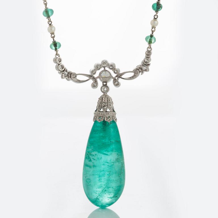 An emerald and diamond pendant with the emerald measuring ca 14.8 X 13.7 X 33.0 mm.