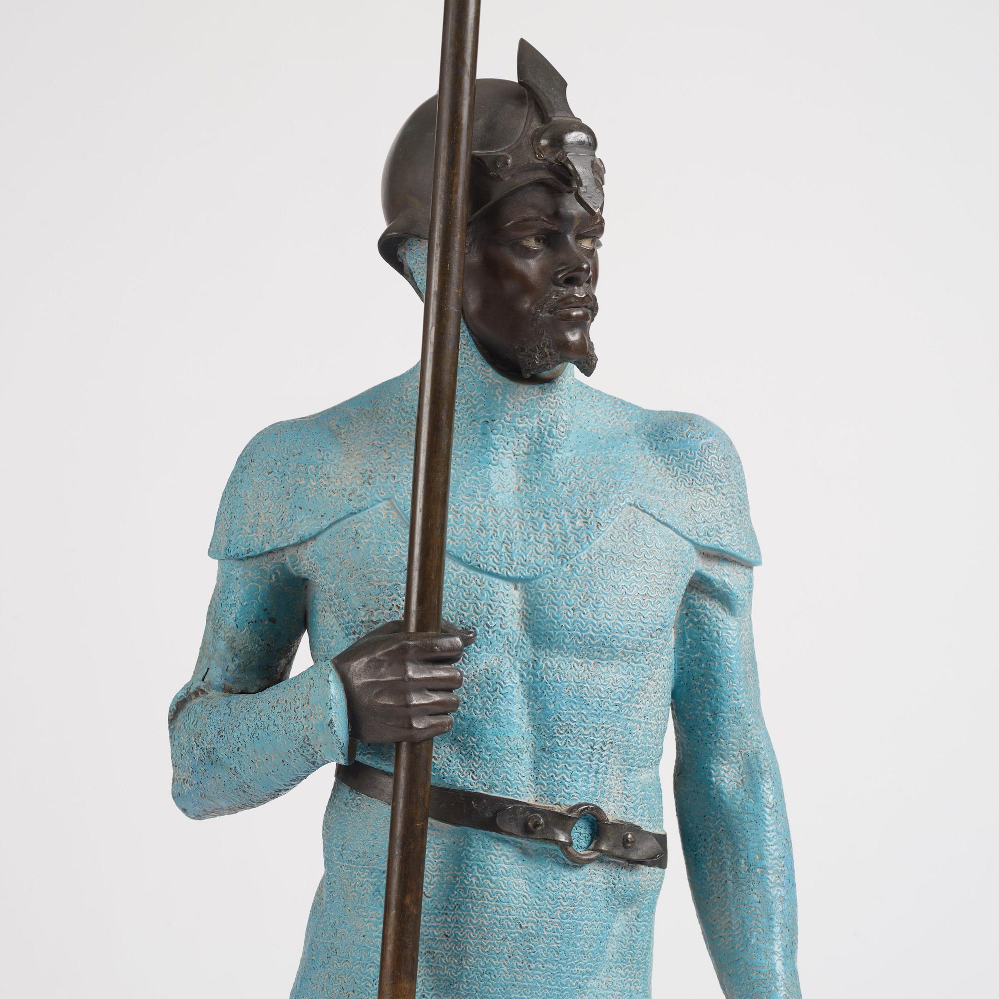 A bronze sculpture of a man in armour, late 19th century.