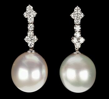 1099. A pair of cultured South sea pearl and diamond earrings.