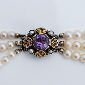 A cultured saltwater pearl collier with silver lock with purple faceted amethyst.