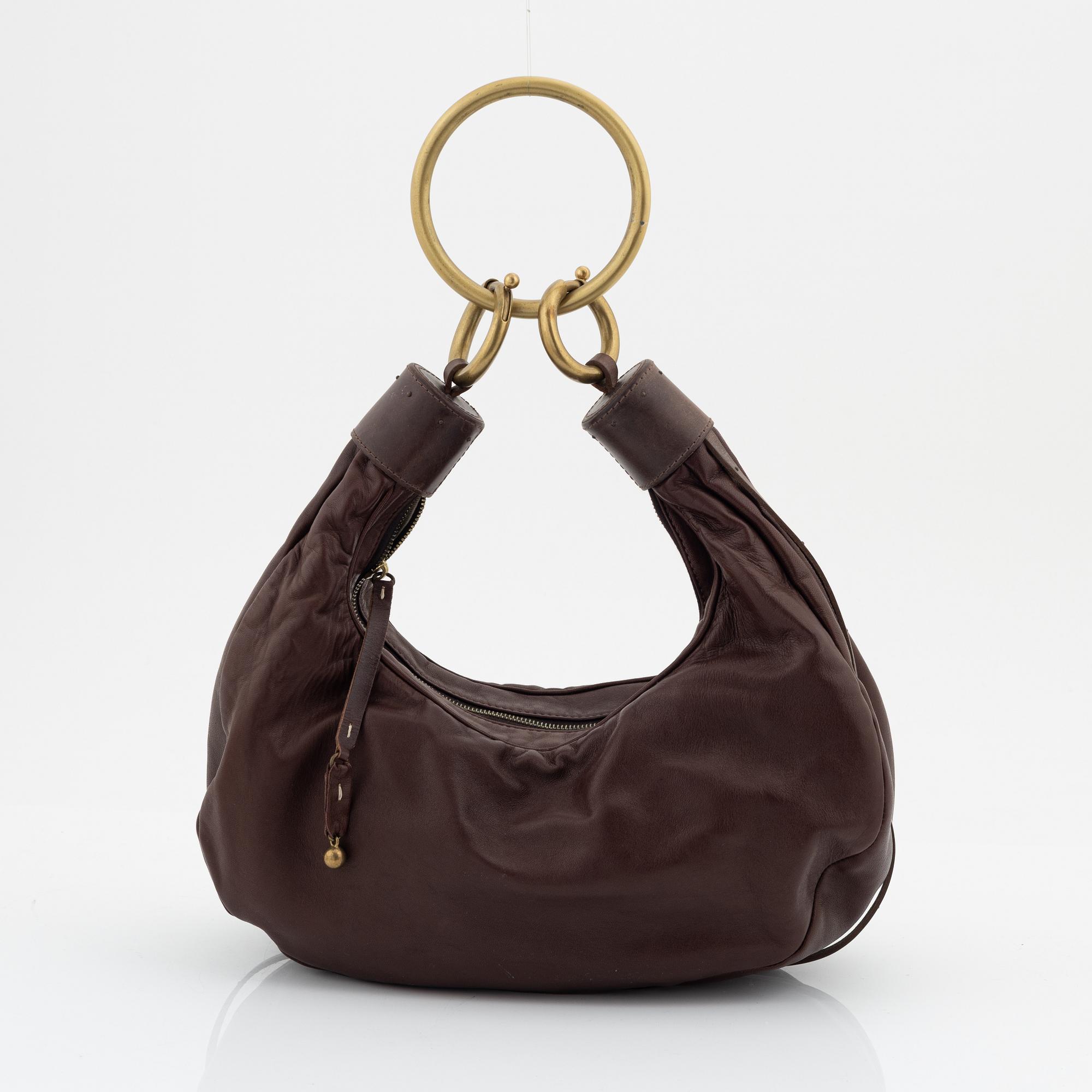 Chloé, a brown leather and brass bag.