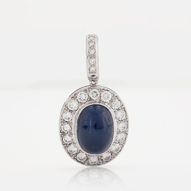 A PENDANT set with an oval cabochon-cut sapphire and round brilliant-cut diamonds.