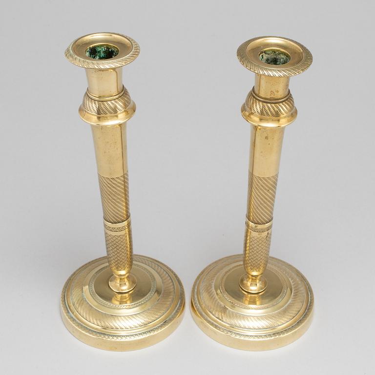 A mid 19th Century pair of brass candle sticks.