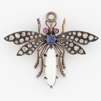 Brooch/pendant in the form of a bow tie, silver with opal, sapphire, rubies, and rose-cut diamonds.