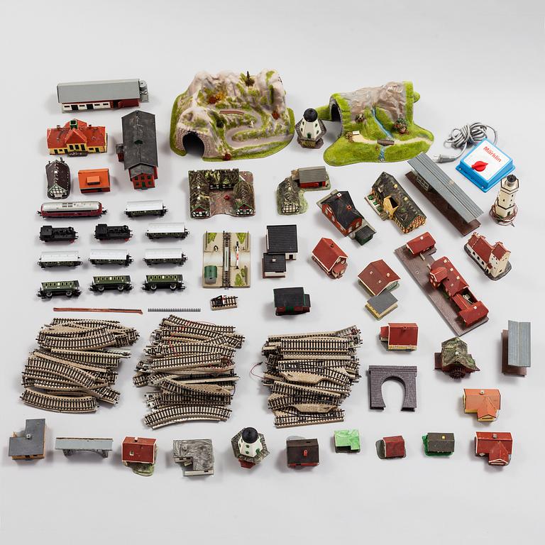 A model train set with locomotives, wagons, rail H0, Danish village houses, tunnel, mountain and more.