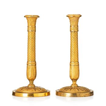 150. A pair of French Empire ormolu candlesticks, Paris, early 19th century.
