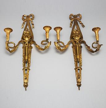 A pair of Louis XVI style brass wall sconces, first half of the 20th Century.