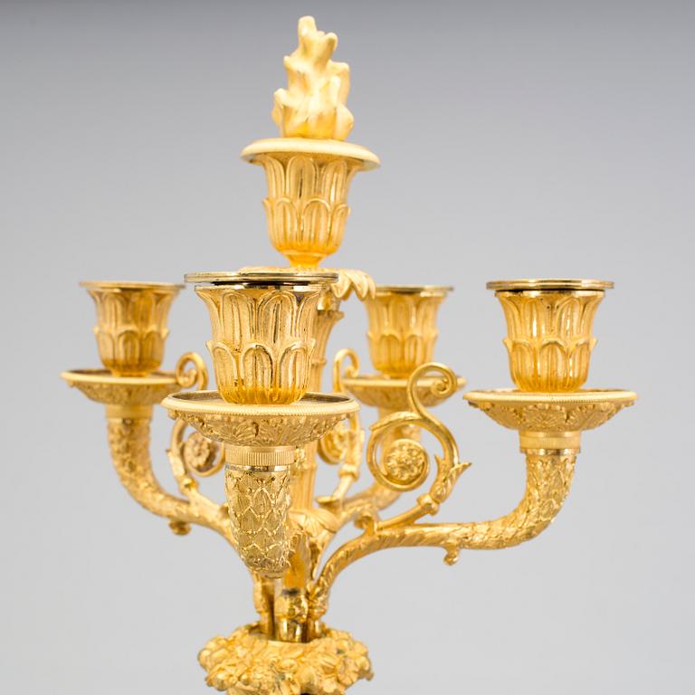 A large pair of first half of the 19th century gilt and patinated bronze five-light candelabra.