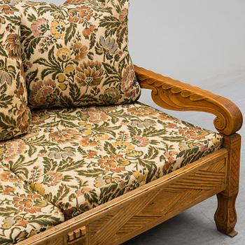 KNUT FJAESTAD, a folk art stained wood sofa/bed,  Sweden, early 20th C.