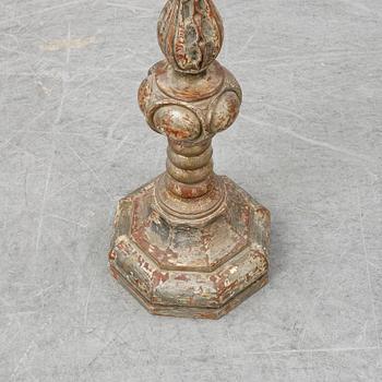 A wooden altar candlestick.