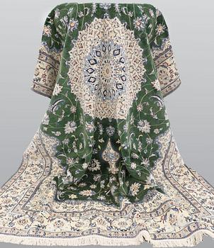 A Nain carpet, part silk, approx. 302 x 202 cm.