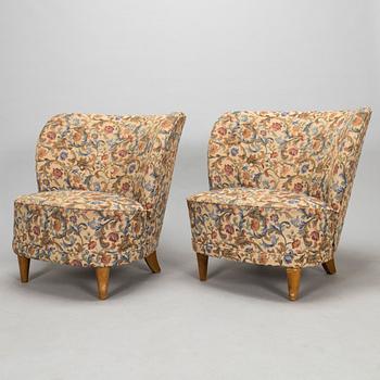 A pair of mid-20th-century armchairs.