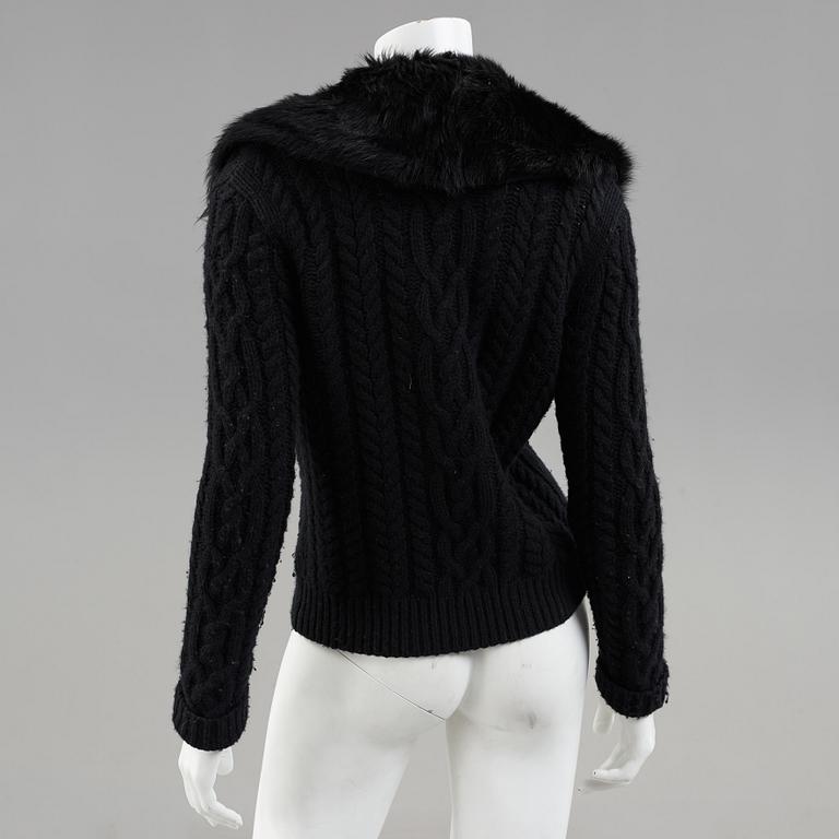 A black knitted cashmere cardiganwith fur collar by Ralph Lauren.