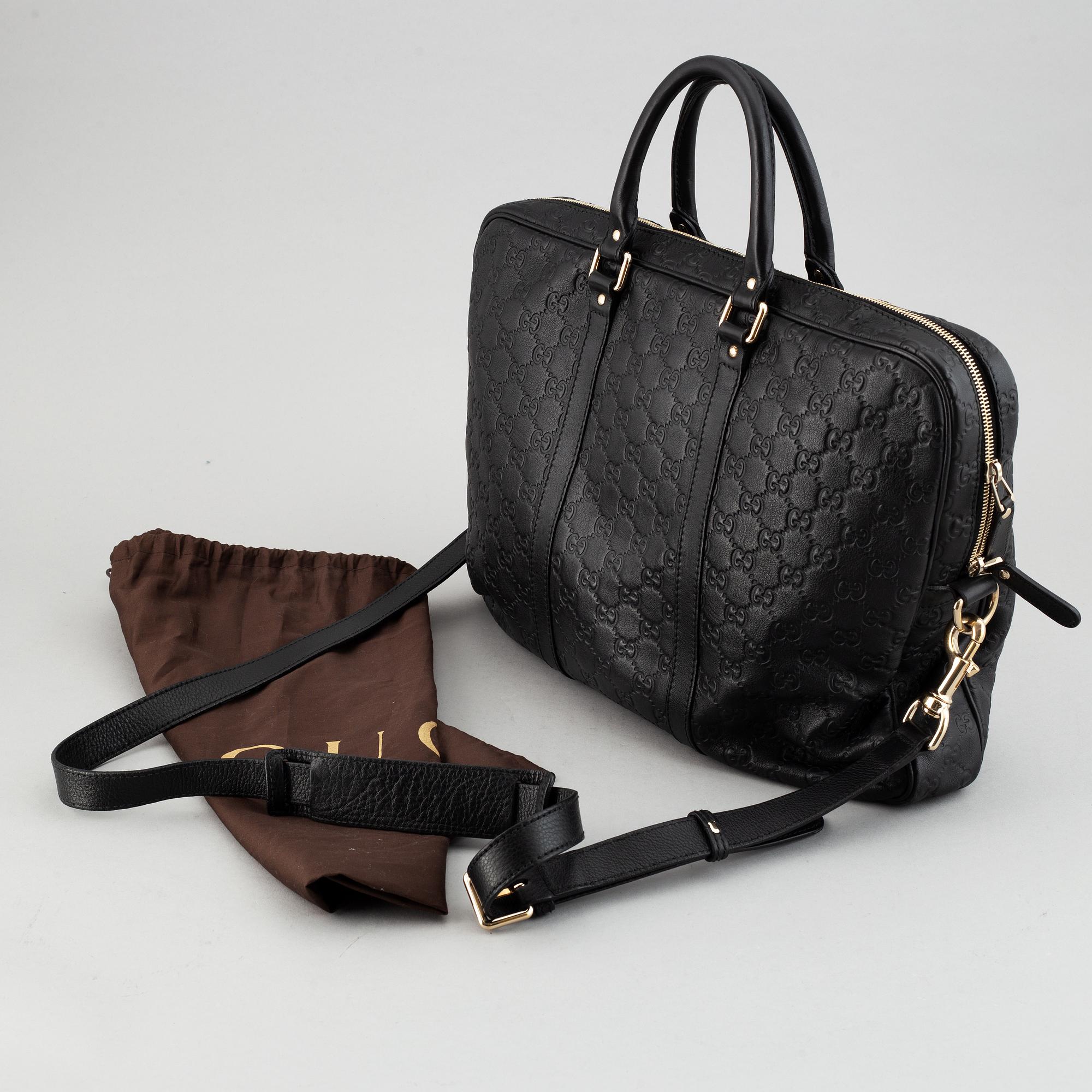 Gucci, a monogram leather bag/laptop-bag.