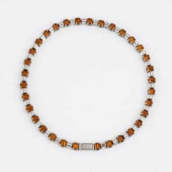 Prada, a rhinestone necklace.