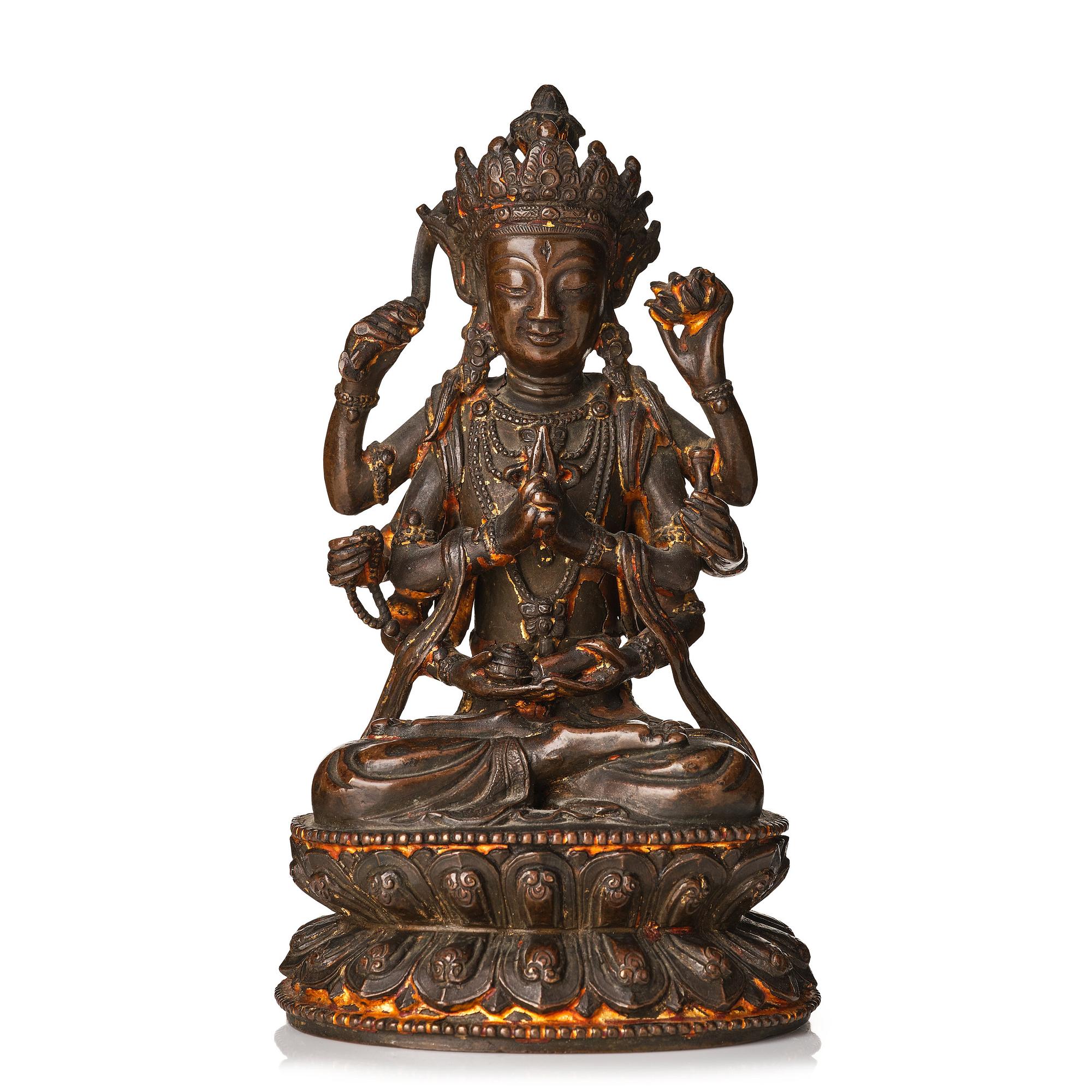 A cold gilt copper alloy figure of eight armed Boddhisattva Avalokiteshvara, late Ming dynasty.