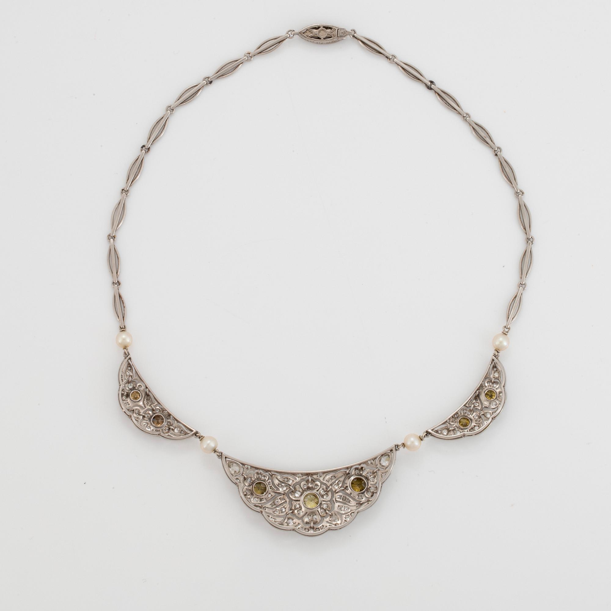 A platinum necklace set with diamonds and pearls.