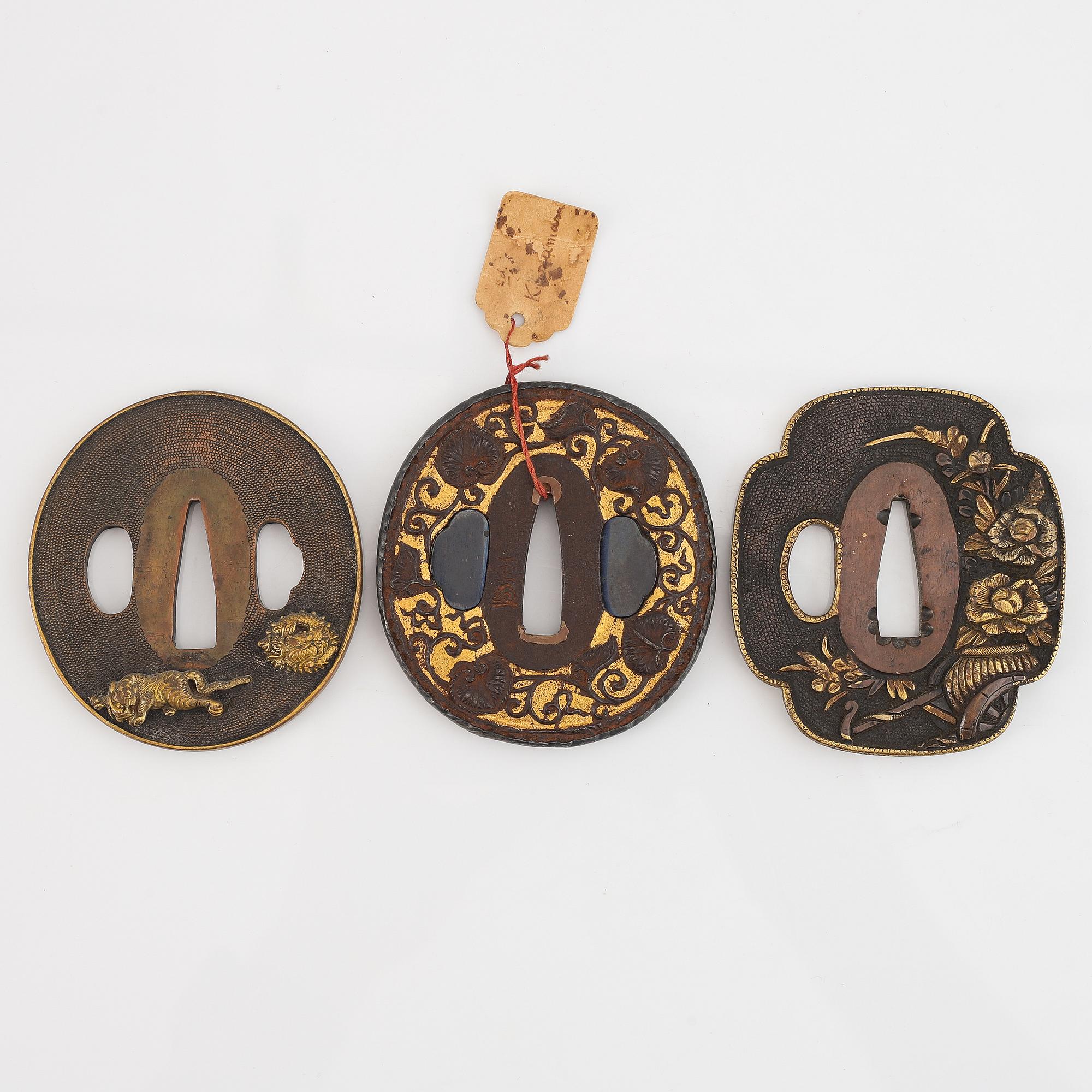 Five tsubas, 18/19th Century, one signed.