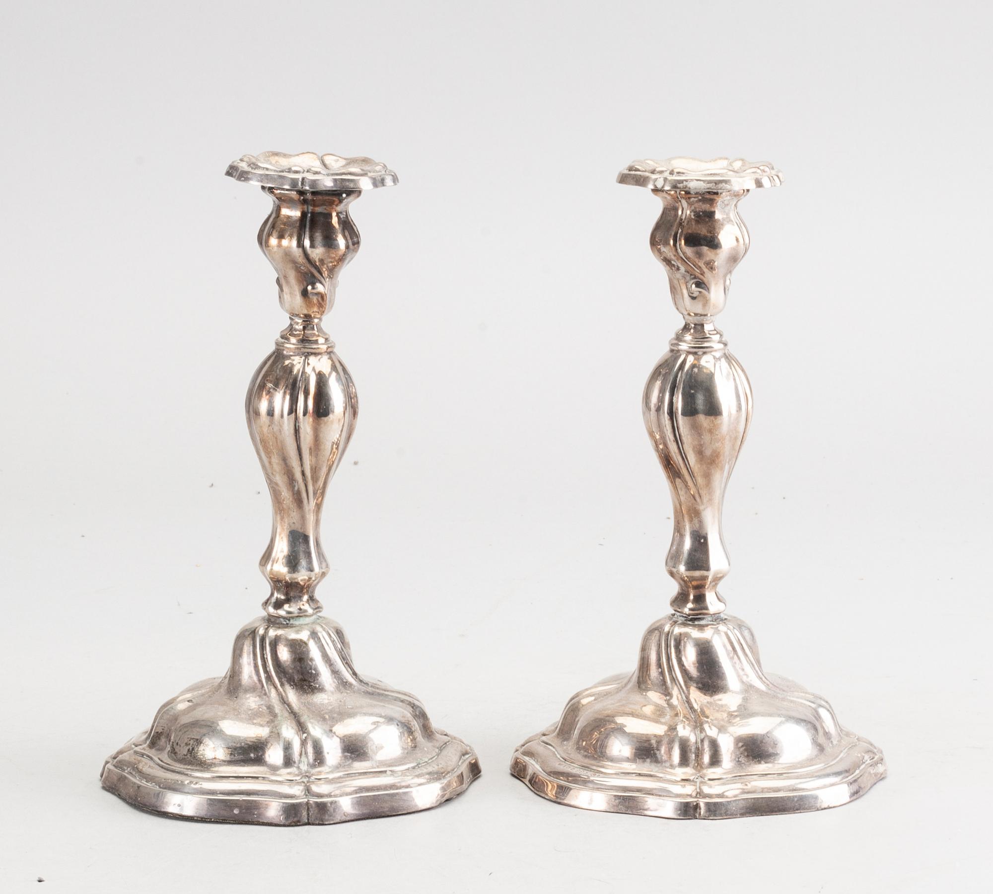 A 20th century pair of silver candle sticks rococo-style, height ca 22 cm.