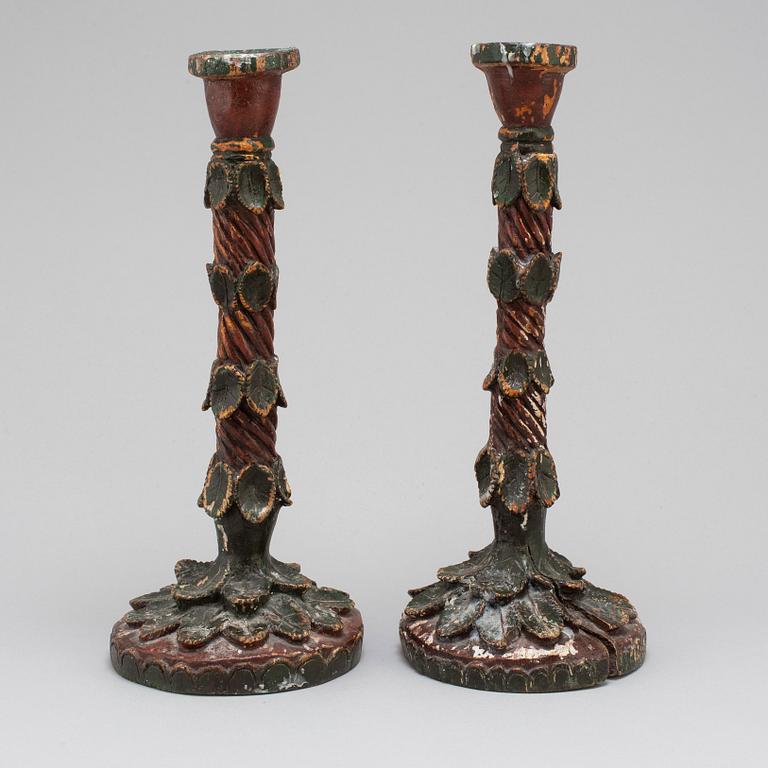 A pair of wooden candle sticks, first half of the 19th century.