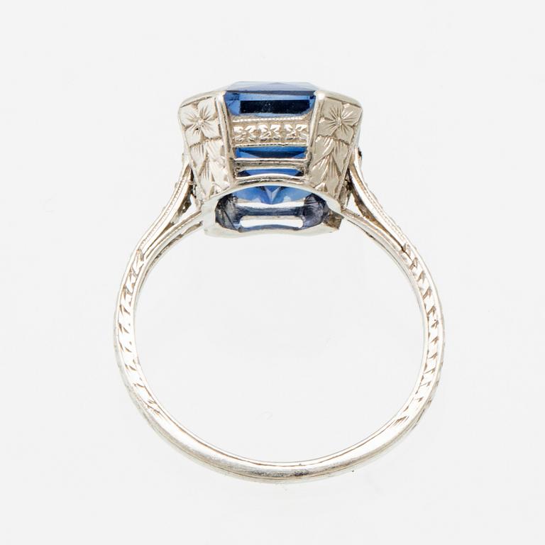 A Shreve & Co Platinum Ring set with a Synthetic Sapphire and Round Brilliant Cut Diamonds.