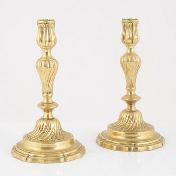 A pair of French Louis XV brass candlesticks, mid 18th century.