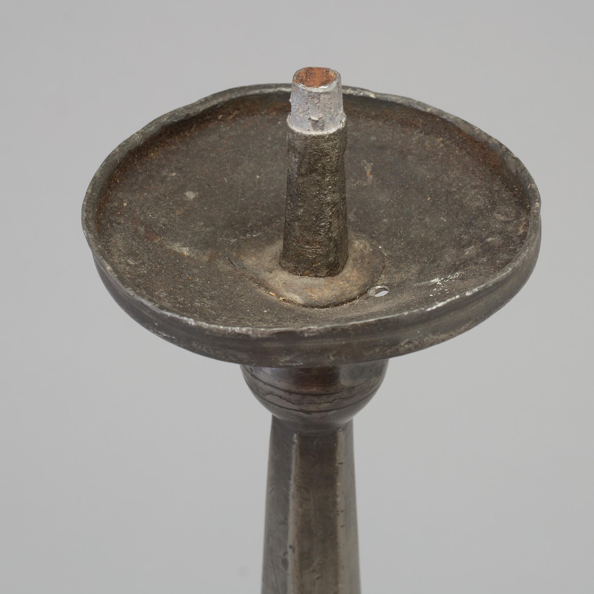 A 17th century pewter candlestick.