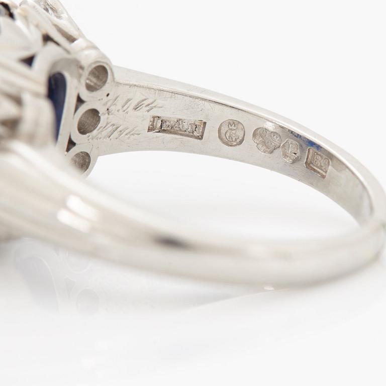 A RING set with a faceted sapphire.