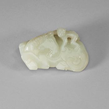 A carved white nephrite belt hook of a recumbent horse and a monkey, Qing dynasty (1644-1912).