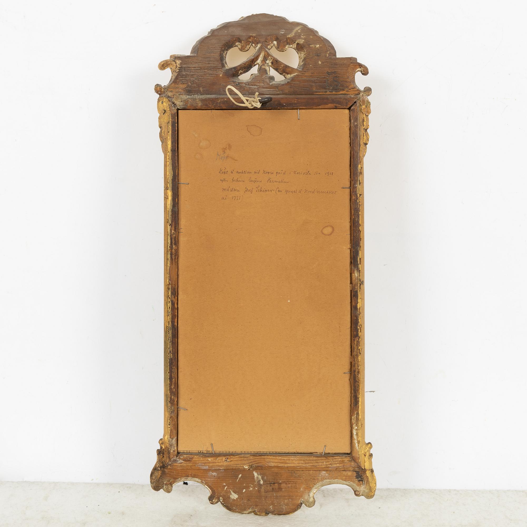 A giltwood rococo mirror by J. Schürer (master in Stockholm 1769).