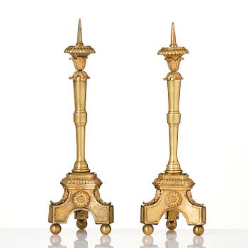 A pair of presumably Italian Empire ormolu candlesticks, early 19th century.