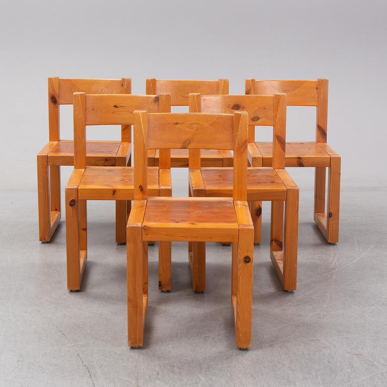 A set of six mid 20th century pine wood chairs with wheels.