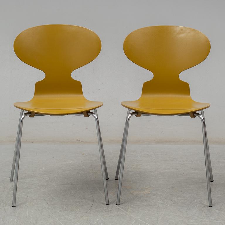 BRUNO MATHSSON & PIET HEIN, and ARNE JACOBSEN, a 'Supercirkel' table and two 'Myran' chairs, from Fritz Hansen.