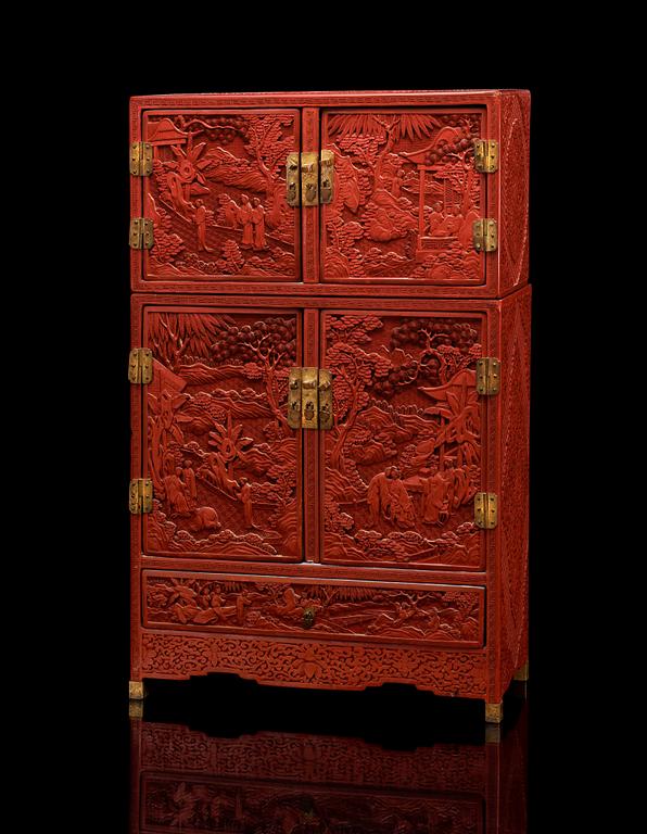 A well carved Cinnaber lacquer 'Kang'Cabinet, Qing dynasty, 18/19th Century.