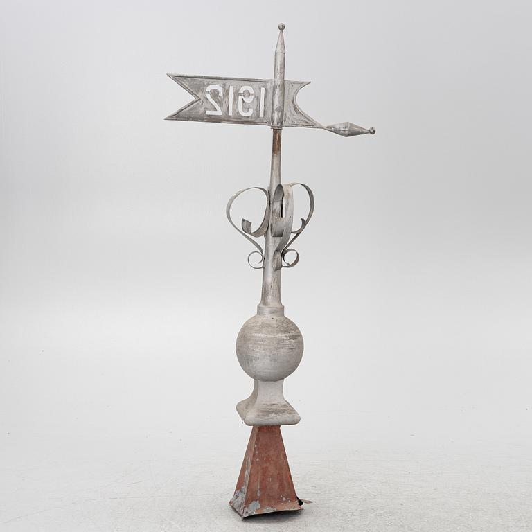 Tower spire with weather vane dated 1912.