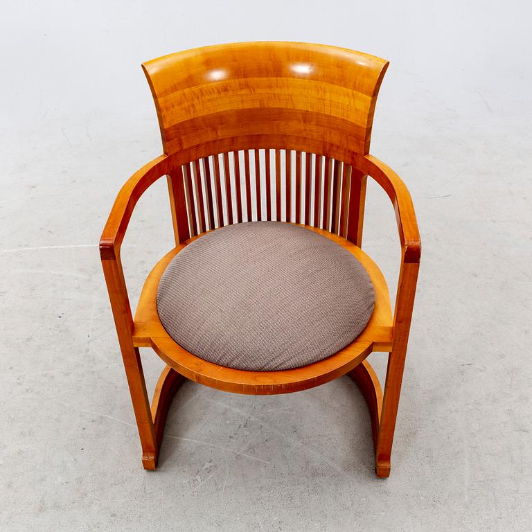 A cherry wood model 606 'Barrel' chair by Frank Lloyd Wright from Cassina.