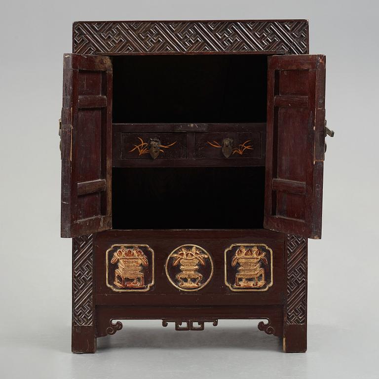 A carved and gilt wooden cabinet, Qing dynasty (1664-1912).