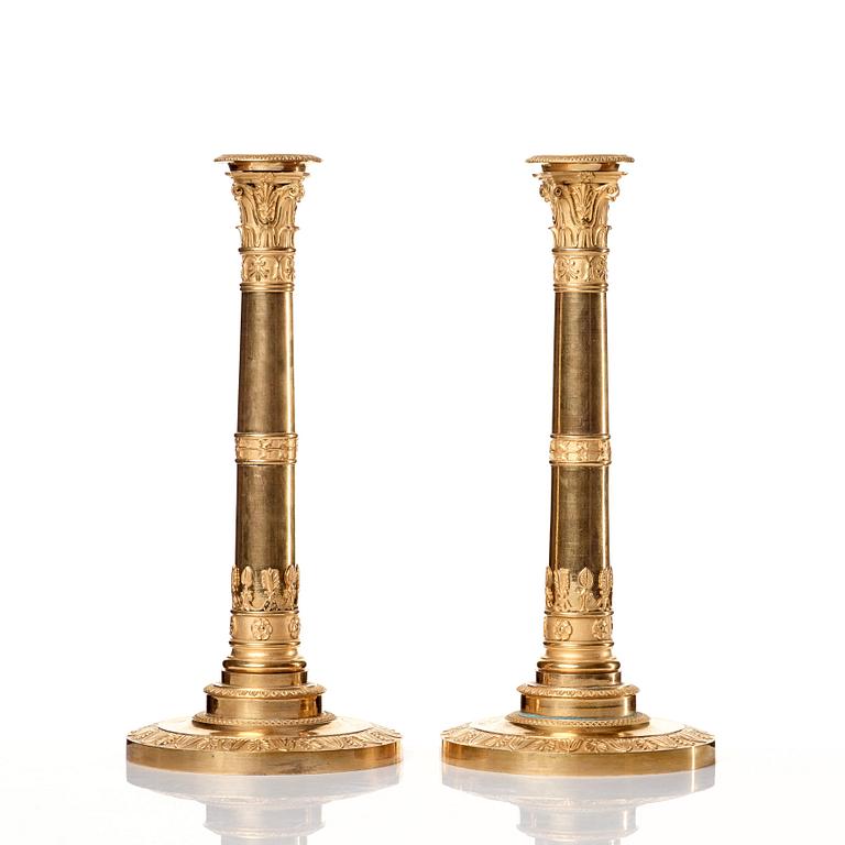 A set of four Empire presumably Russian candlesticks in gilded bronze.