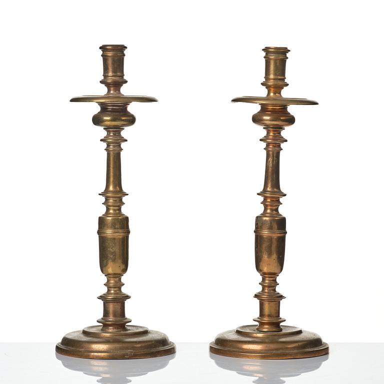 A pair of baroque brass candlesticks, 18th century.