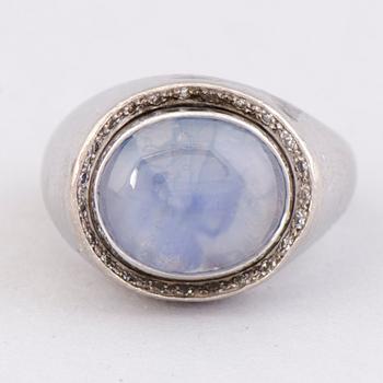 A RING, cabochon cut star sapphire, 8/8 cut diamonds, 18K white gold. A. Tillander, Helsinki Finland 1974.