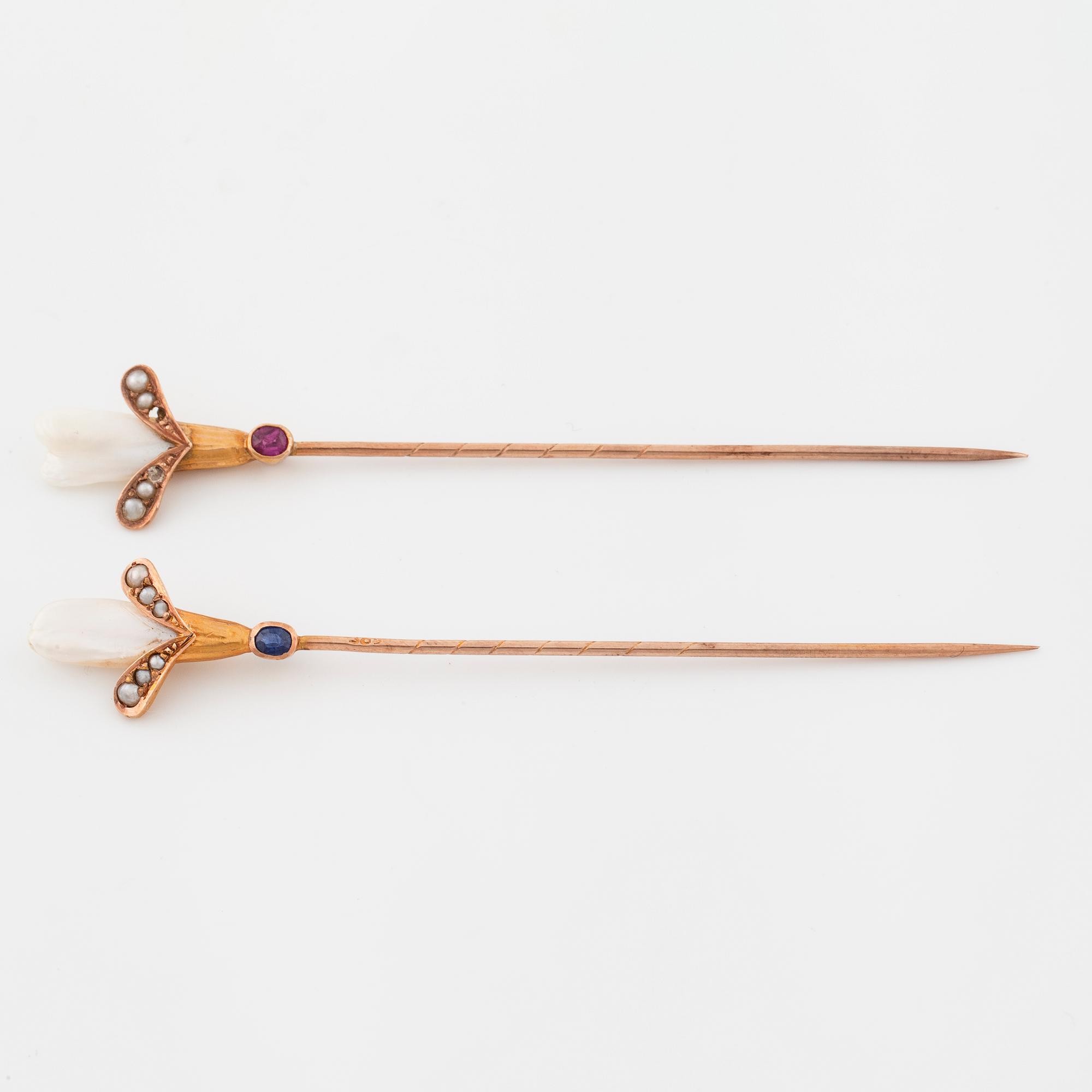 Two pins set with cultured pearls and a synthetic ruby and a synthetic sapphire.