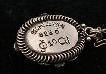 A PENDANT, 826 silver, amber, agath.  Georg Jensen Copenhagen 1909-14. Length 3,1 cm. Chain 44 cm.