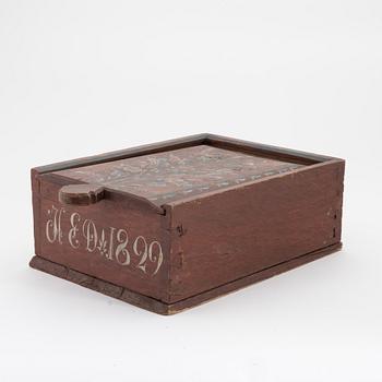 A Swedish folk art painted box with sliding lid, dated 1829.