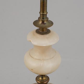 An alabaster mantle clock and pair of candlesticks, circa 1900.